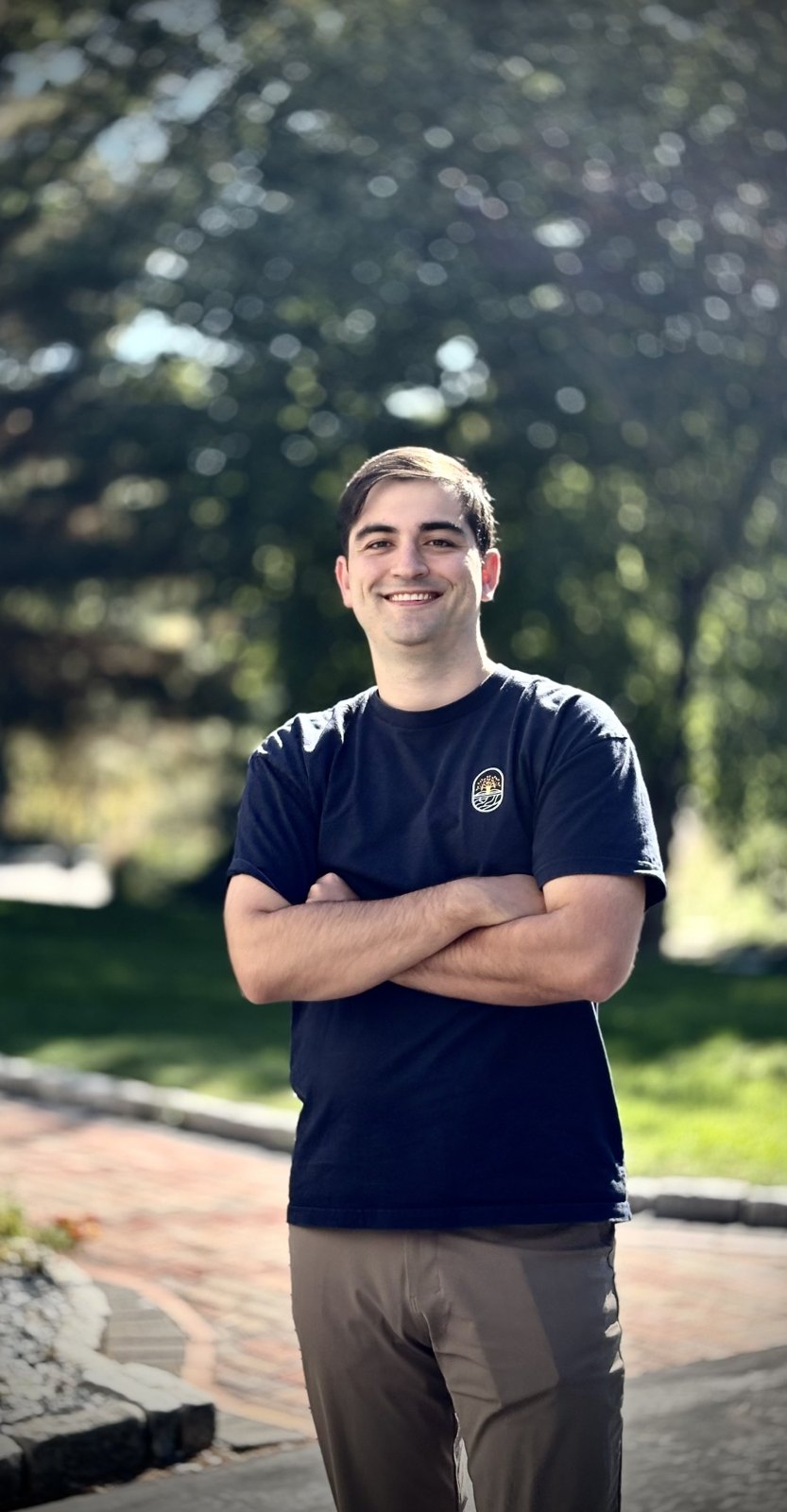 Arban Nazarko smiling outdoors in a navy Score 54 shirt